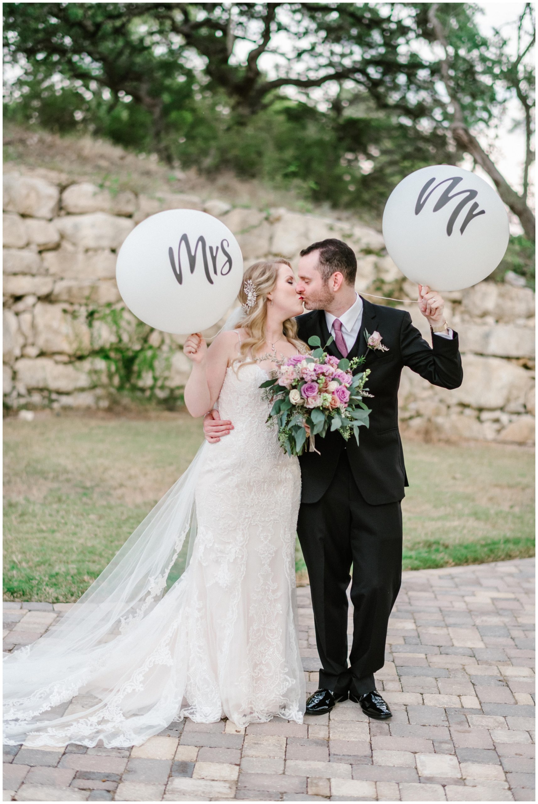 Bride and groom with Mr. and Mrs. balloons 