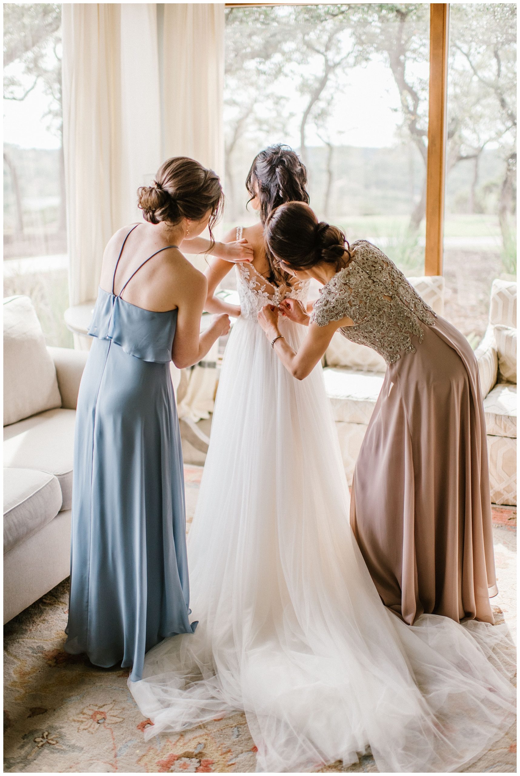 Bride Getting Ready with the help of her Mom and Maid of Honor