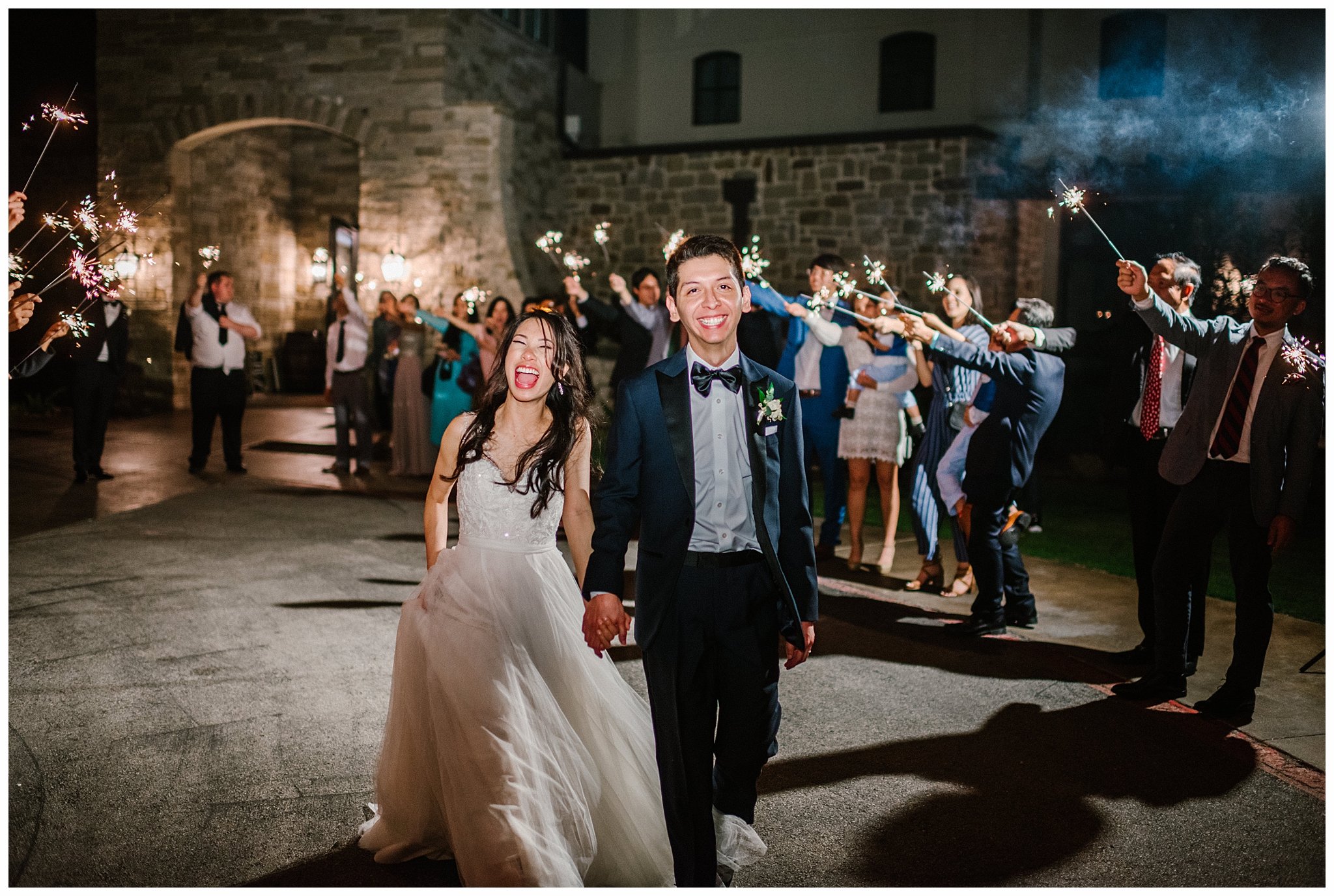 Cute couple smiling during sparkler exit