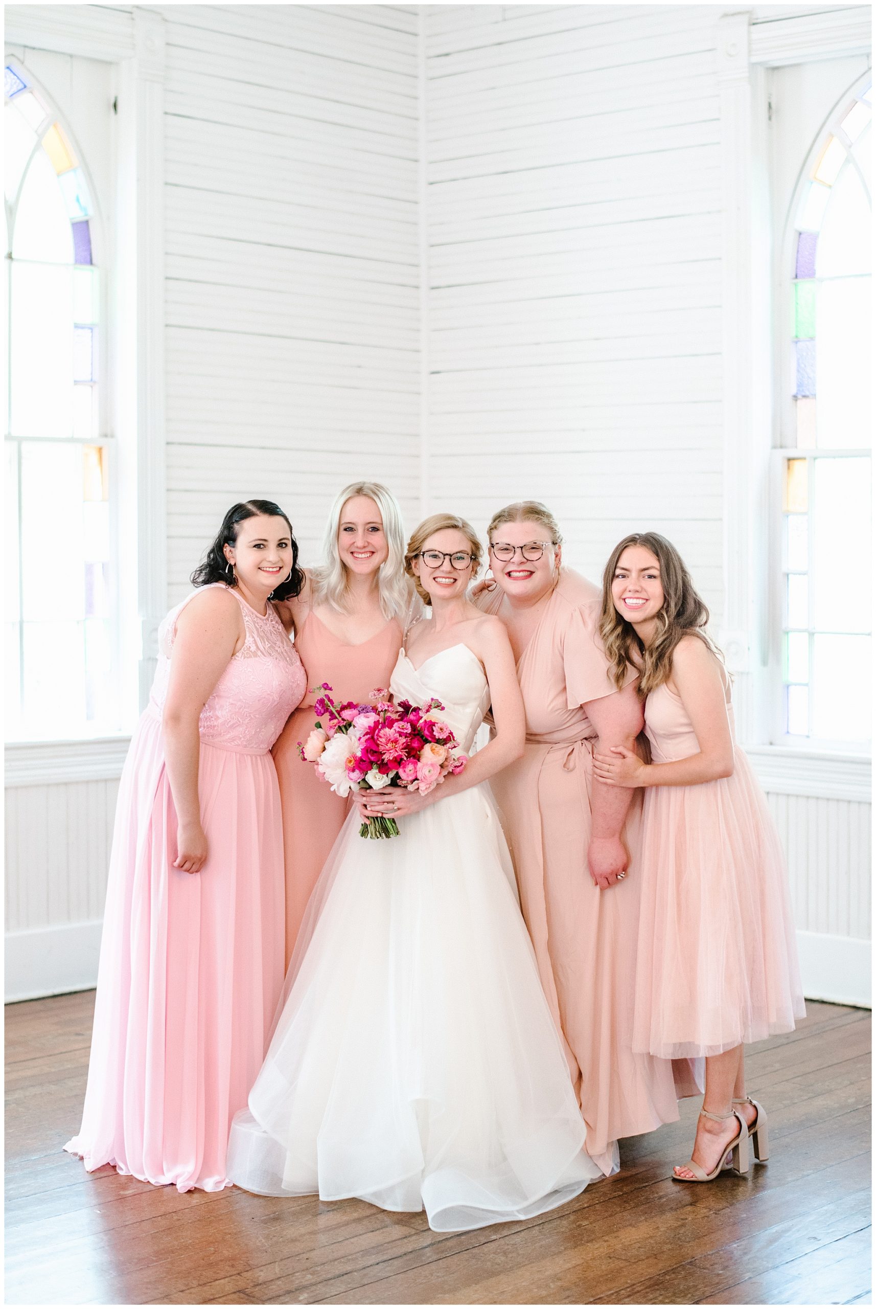 beautiful blush bridesmaids and bride in unique ballgown